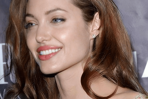 Angelina Jolie posing on the red carpet in a designer gown